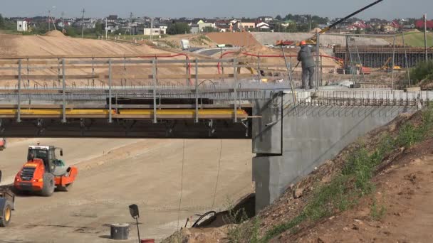 Viaducto de hormigón de riego obrero con herramienta de alta presión, suelo nivelador de rodillos — Vídeos de Stock