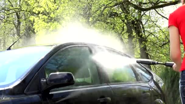 Wassertropfen spritzten aus mit Hochdruckwerkzeug gewaschenem Auto. — Stockvideo