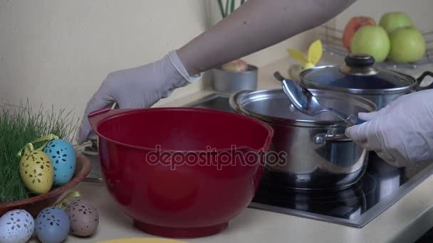 Vrouw handen nemen eieren verpakt in materiaal uit pot kokend water met verf — Stockvideo