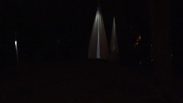 Children swing in modern lighting swing hanging on trees at night. 4K — Stock Video