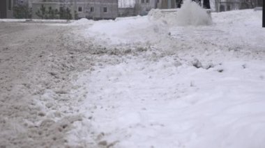 Kar temizleme makinesi ile sokak kaldırım kardan adam temizler. Portre. 4k
