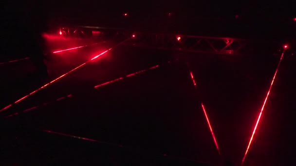 People walk red laser beams at security alarm system demonstration at night. 4K — Stock Video