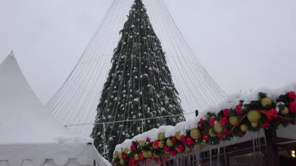 Christmas toy decorations covered with icicle and snow. Blizzard snow falling — Stock Video