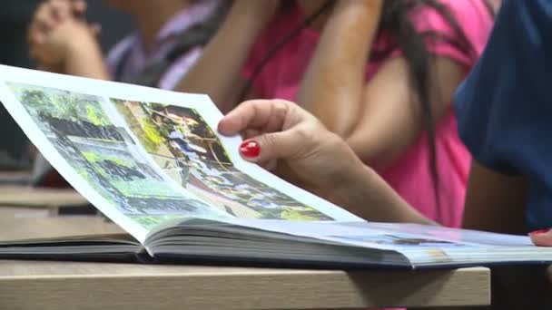 Kazakh woman thumb book and children wear virtual reality 3D VR headset glasses — Stock Video