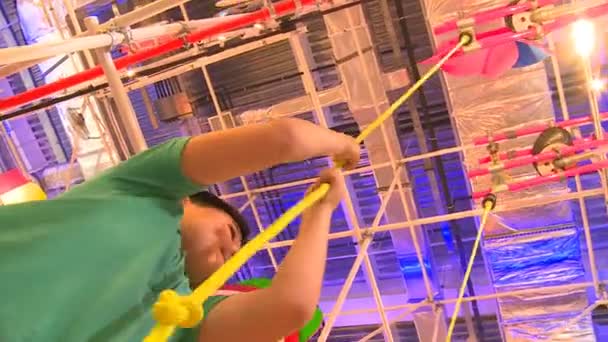 Мальчик дергает веревку на красочной детской площадке в павильоне Австрия ЭКСПО-2017 — стоковое видео