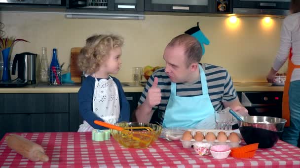 Portrait of happy family making cake together in kitchen — Stock Video