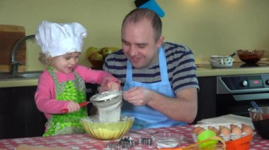 Pasta pişirme için un eleme onun sevimli kızı kızla mutlu adam