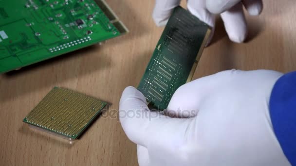 Especialista en informática examinar el módulo de memoria RAM sobre fondo de madera — Vídeos de Stock