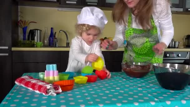 Le mani di madre e figlia che preparano la pasta a torta della tazza su tavolo . — Video Stock