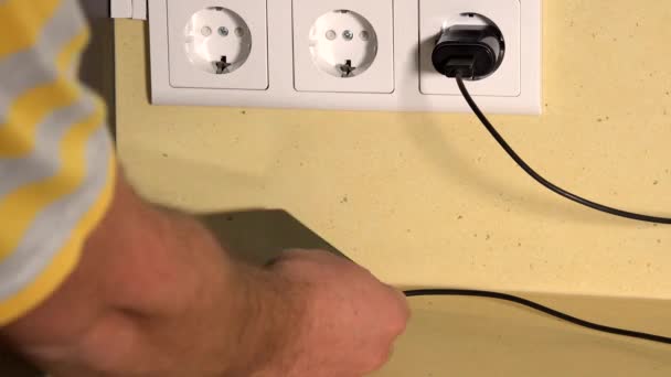 Male hand put smart phone on wireless charger — Stock Video