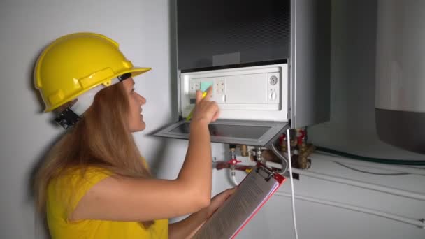 Technician girl inspect maintenance gas boiler heating system at private house — Stock Footage Technician girl inspect maintenance gas boiler heating system at private house Stock Footage