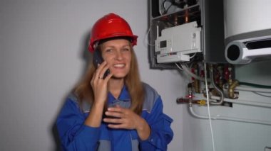 Teknisyen kibar kadın patronuyla ya da müşterisiyle telefonda konuşuyor.