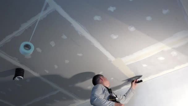 Handyman Man Spackling Gypsum Plasterboard Ceiling With Putty