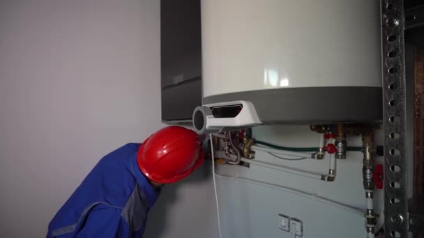 Técnico profissional homem inspecionando caldeira a gás para problemas. Trabalhador masculino — Vídeo de Stock