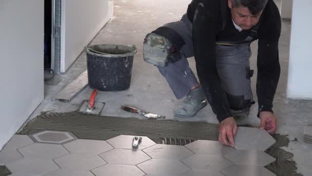 Carrelage qualifié pose carreaux de plancher hexagonal dans le couloir — Video