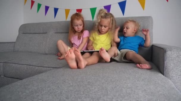 Los niños adictivos enojados luchan por jugar con la tableta. movimiento de cámara — Vídeo de stock