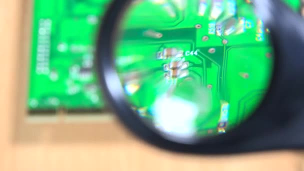 Pc card detail looking with magnifying glass at pc repair service. — Stock Video