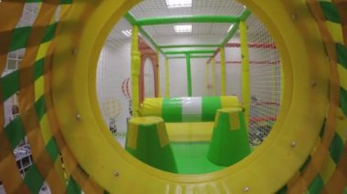 Indoors game center. Moving back through tunnel. Gimbal motion shot