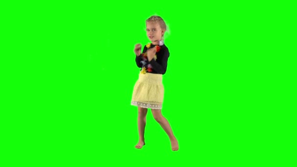 Happy young girl dancing and smiling over green background. — Stok video