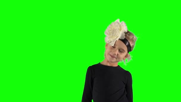 Funny girl blink with one eye posing on chroma key green background — Stock video