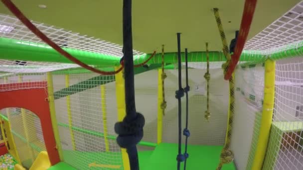 Rope for climbing up at indoors game. Gimbal motion down shot — Stock Video