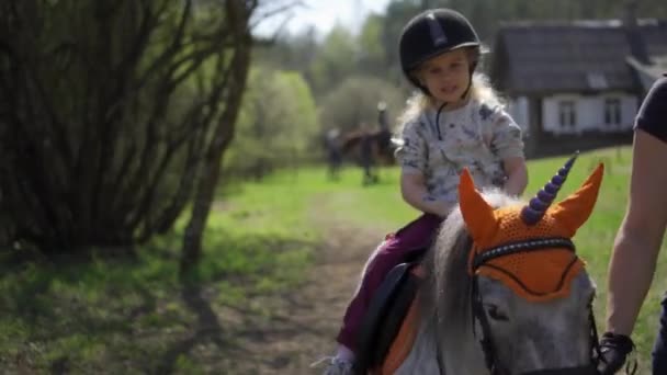 Lovely girl child ride unicorn pony horse. Gimbal stabilizer movement shot — Stock Video