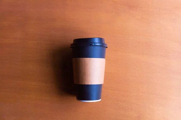 paper take away coffee cup on wooden background