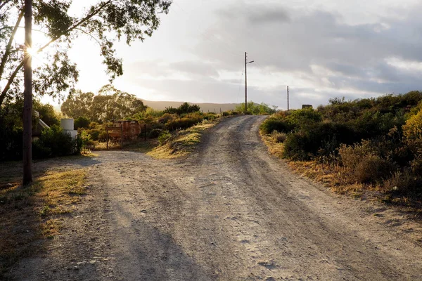 a fork in the road on a dirt road in the countryside