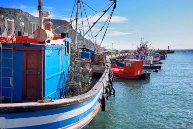 Kalk Bay Harbour, Cape town, South Africa - 16 May 2019 : Traditional wooden fishing boats are moored in a small harbour in Cape Town, South Africa