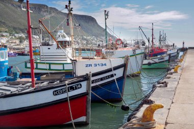 Kalk Bay Harbour, Cape town, South Africa - 16 May 2019 : Traditional wooden fishing boats are moored in a small harbour in Cape Town, South Africa