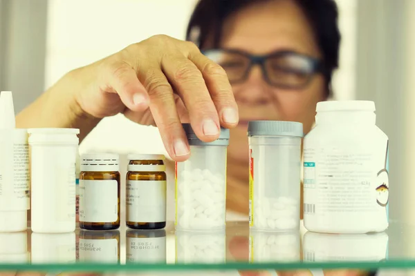 Woman reading prescription bottle — Stock Photo, Image