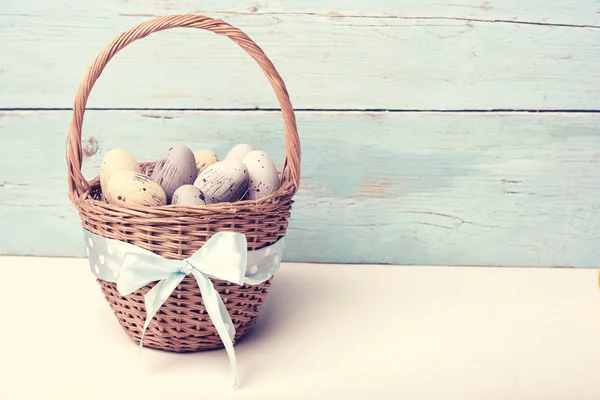 Patele huevos de Pascua en la cesta de tablas de madera — Foto de Stock