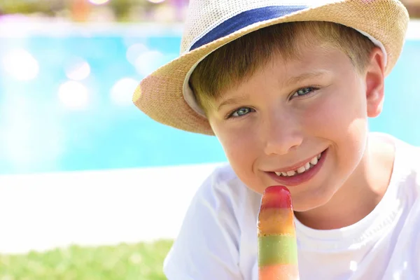 Lindo niño con helado al lado de la piscina — Foto de Stock