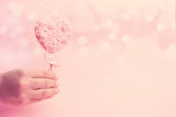 Cute pink lollipop on female hand — Stock Photo, Image