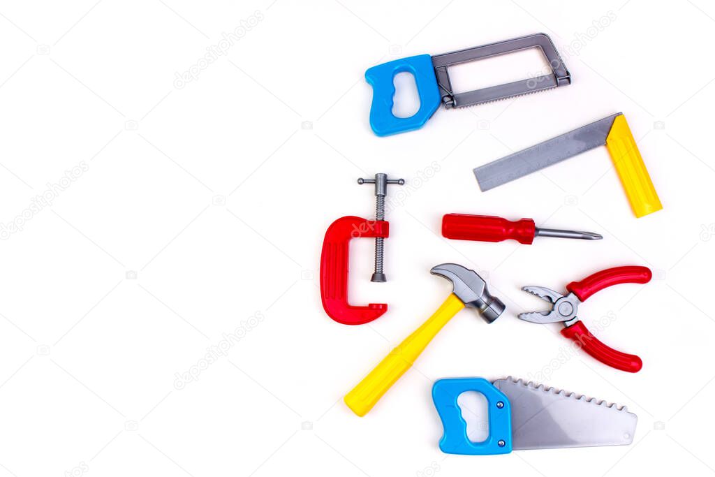 Toy. professional repairing implements for decorating and building renovation set on the on white background. Electrical tools. Top view. Copy space for text.