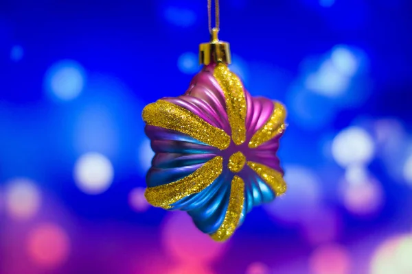 Christmas tree ornaments on a bright background, made at home with a home light on a laptop