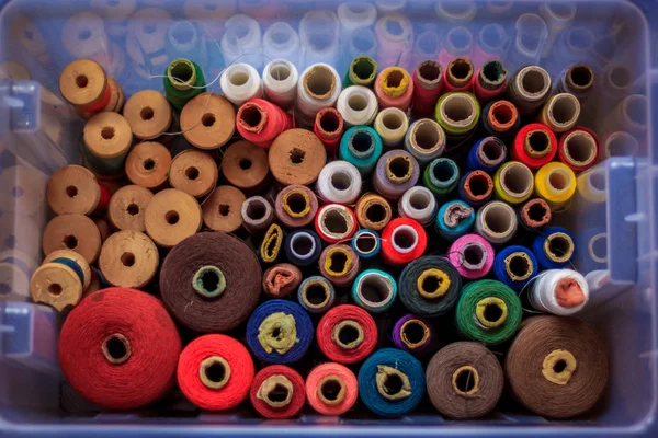 Multicolored tangles of thread are gathered in one box