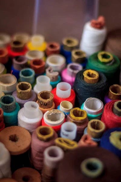 Multicolored tangles of thread are gathered in one box