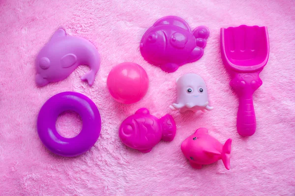 Baby pink toys on a pink background