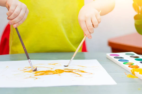 The boy draws with paints . Sit at home. The remote training. Educational classes for children. Article about children\'s leisure. Home children\'s classes. Paints