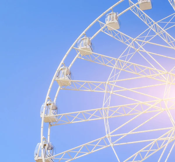 Ferris wheel in the blue sky . view the city from a height. entertainment on vacation . blue sky