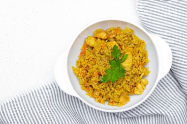 Tabakta pilav. Menü için çekim konsepti. Restoranın yemeği. Baharatlı yemek. Pirinç yemeği. Doğu yemeği. Pilaf beyaz bir plaka ve hafif bir arka plan. İkinci