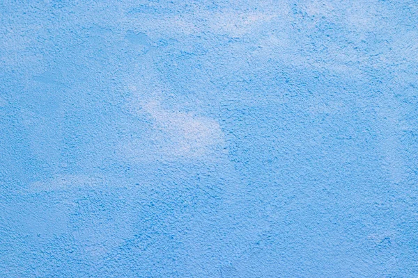 The texture is a patched wall . Blue texture of the wall. Abstract background. . Putty