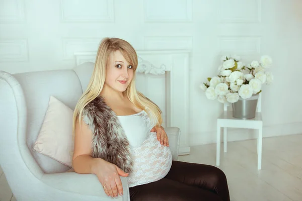 Menina grávida com uma barriga grande em um quarto de estúdio — Fotografia de Stock