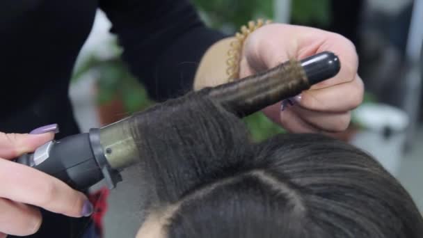 Stylist curling hair for woman. Girl care about her hairstyle — Stock Video