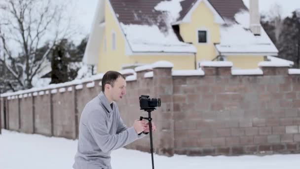 Cara filma vídeo com um estabilizador e uma câmera DSLR — Vídeo de Stock