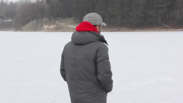 Chico feliz con un Dubai en el hielo cerca del bosque — Vídeo de stock