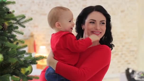 Madre con hijo pequeño cerca de árbol de año nuevo — Vídeos de Stock