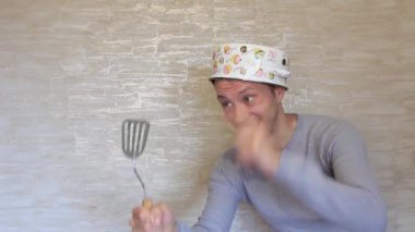 Kafasında tava, elinde mutfak malzemesi olan deli bir adam..