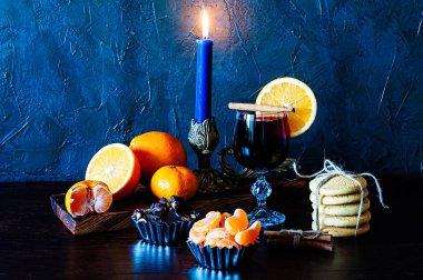 Noel zamanı, kış, cam, tarçın, portakal ve mandalina, kurabiye ve çikolata, şamdandaki mum.